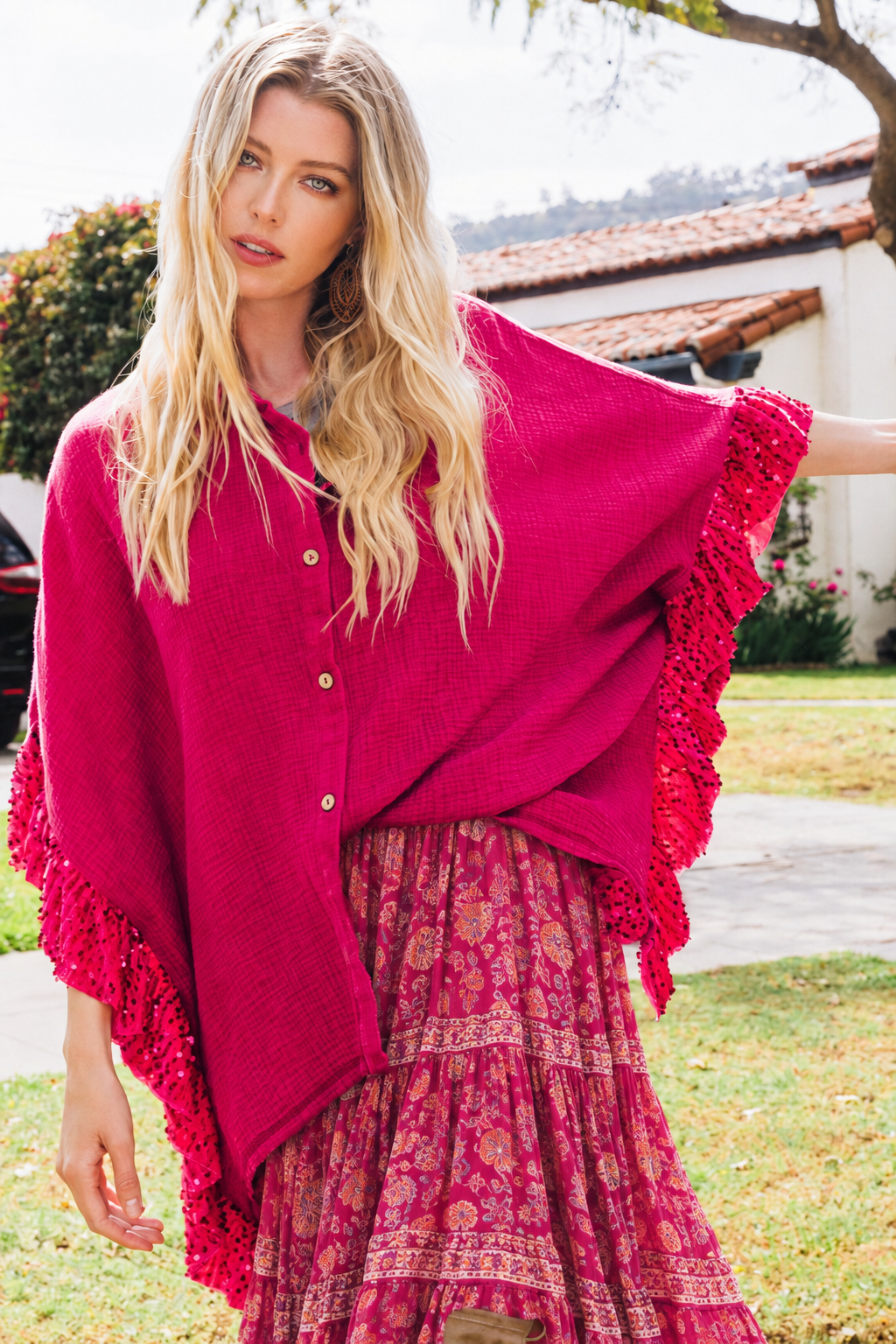 Model wearing magenta poncho with long boho skirt