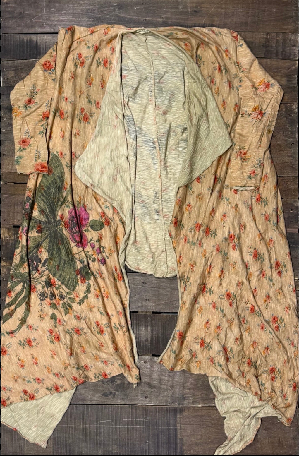 Apricot floral open-front duster with red and orange blooms, an oversized painted botanical panel with a purple flower, and a cream interior lining.