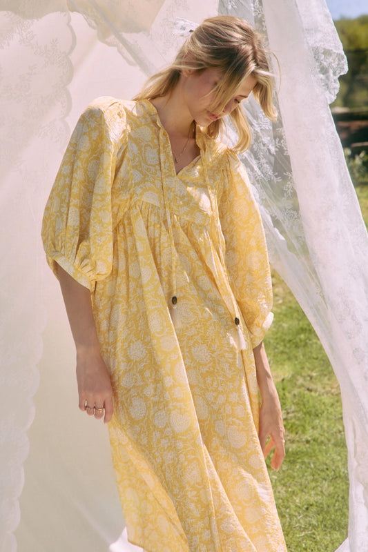 Printed midi dress with a gathered split neckline, tassel ties, and voluminous 3/4 puff sleeves.> yellow