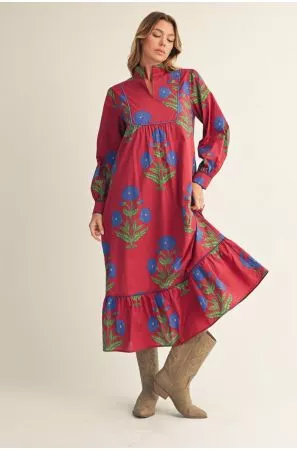 Model wearing a red floral midi dress with long sleeves, a high neckline, and a ruffled hem.