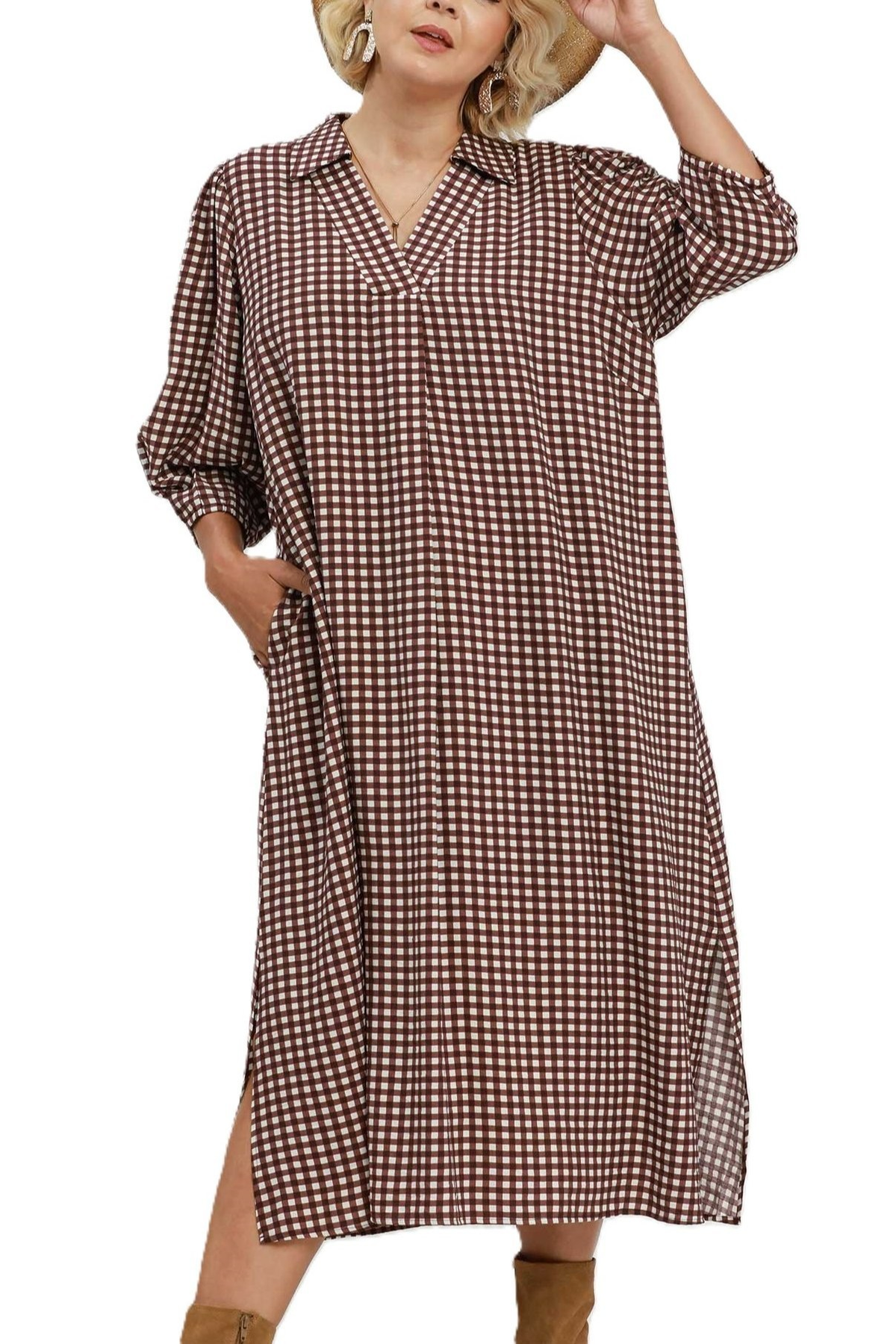Red-brown and white gingham midi shirt dress with collared V-neckline and three-quarter sleeves, styled with a straw hat and tan boots