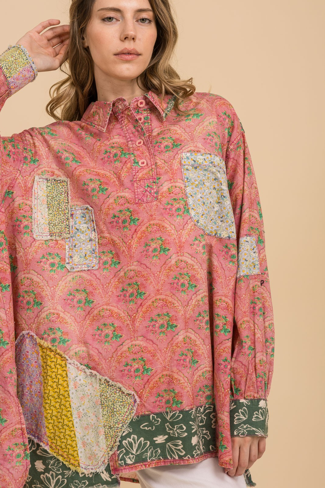 Pink floral collared tunic with mixed-print patchwork, long sleeves, and dark green floral hem and cuffs.