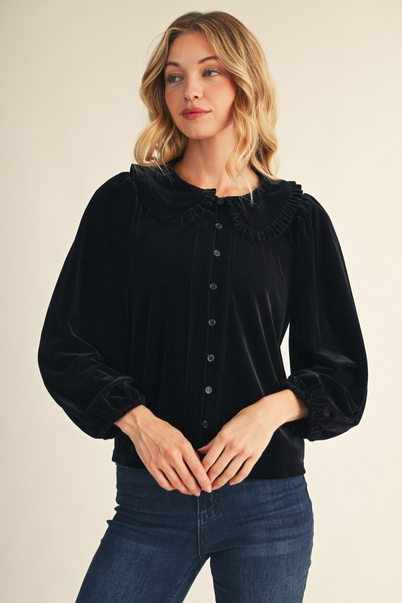 Black velvet-look button-up top with a rounded ruffle collar and long gathered sleeves.