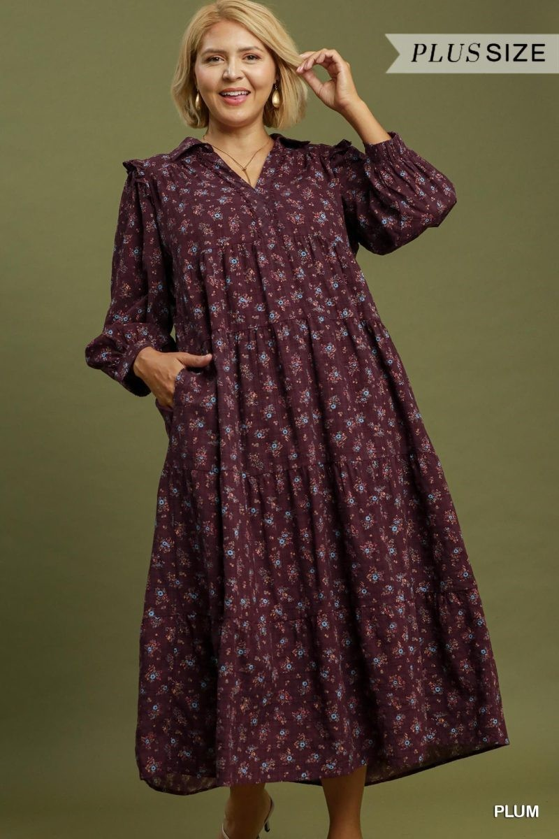 Plus size plum floral maxi dress with a split neckline, long puff sleeves, gathered waist, and tiered skirt