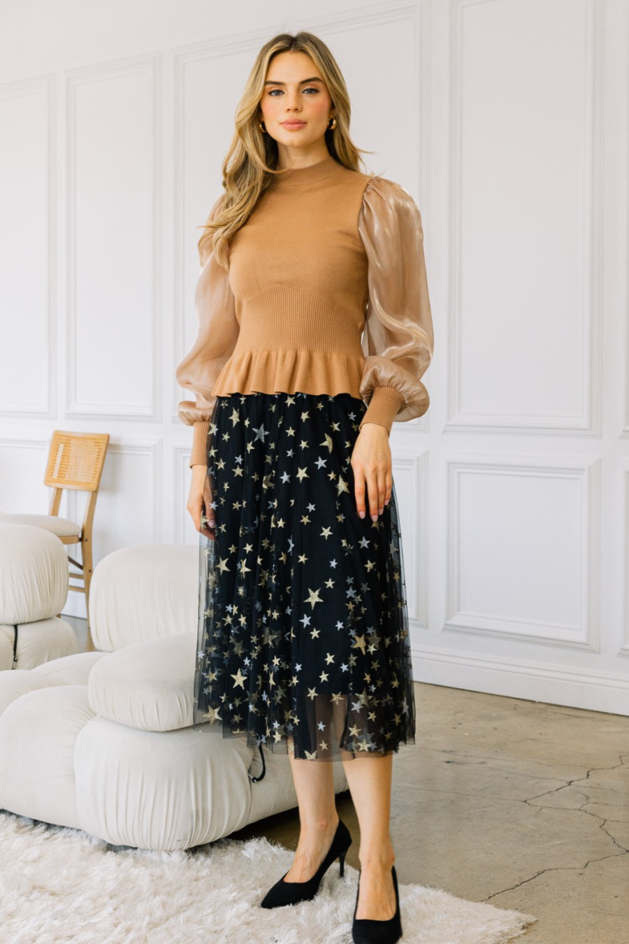 Model wearing black star-patterned tulle midi skirt with tan top and black heels