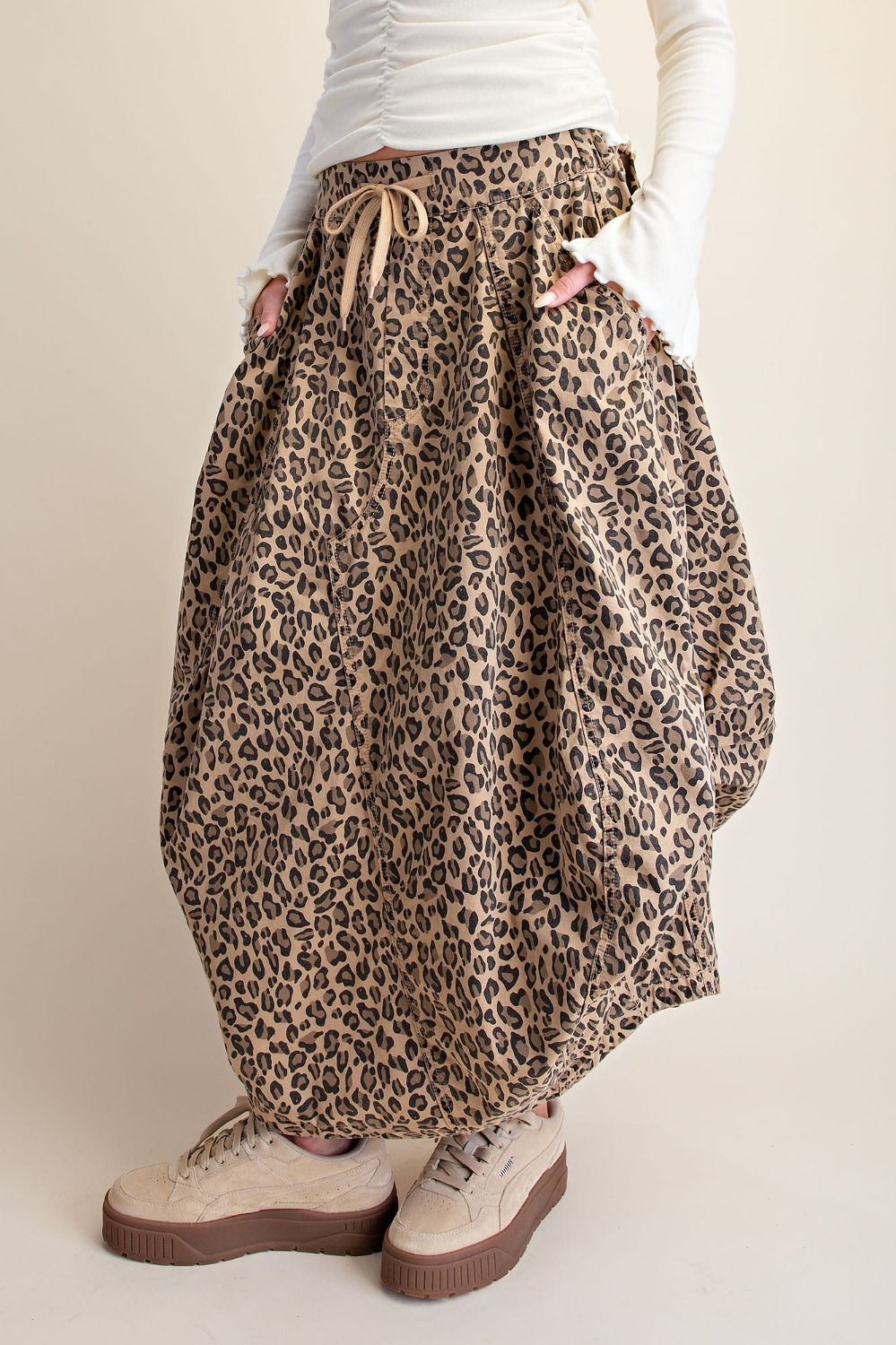 Model wearing a leopard-print drawstring midi skirt with side pockets
