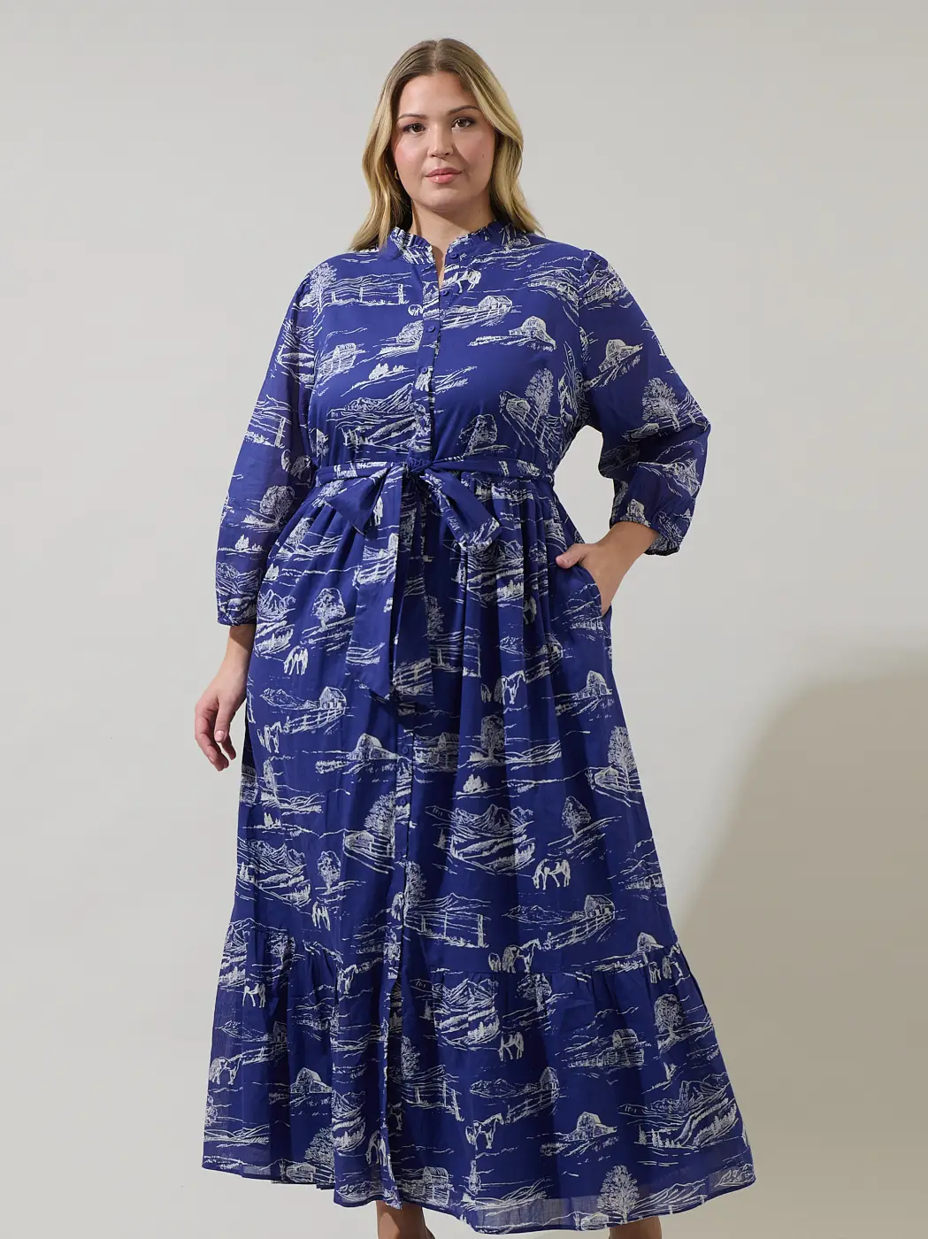 Model wearing a deep blue toile print maxi shirt dress with a tie belt and three-quarter sleeves