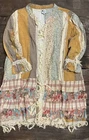Open-front patchwork duster in mustard, muted green, cream, and blush with long sleeves and layered lace trim.