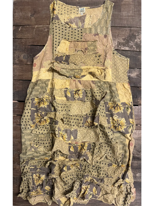 Sleeveless patchwork boho dress with golden yellow flowers, olive leaf sprigs, polka dots, and lattice prints in gold, sage, and taupe