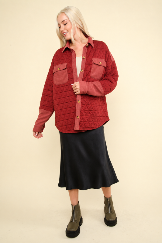 Model in brick red quilted shacket styled with a skirt