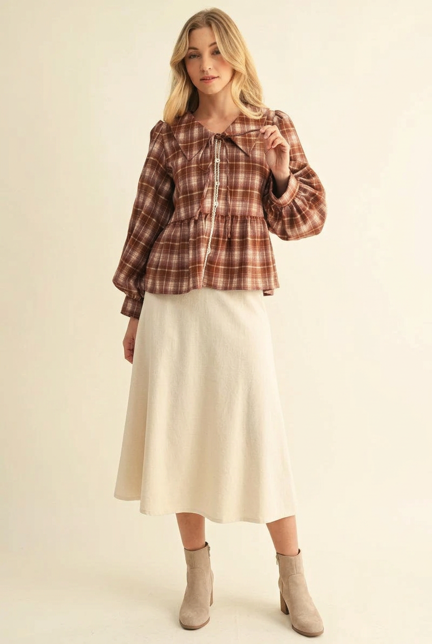 Rust plaid top with a cream midi skirt